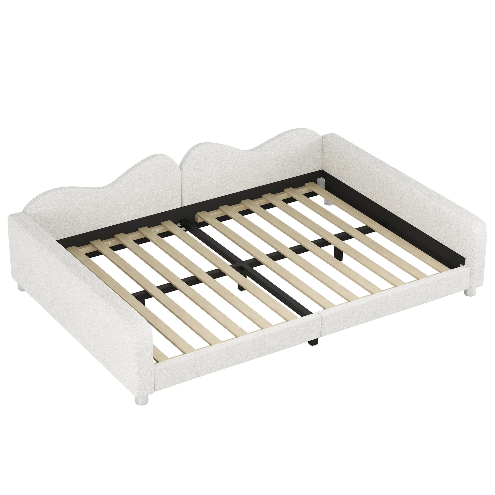 White upholstered twin daybed with wavy headboard and wooden slats