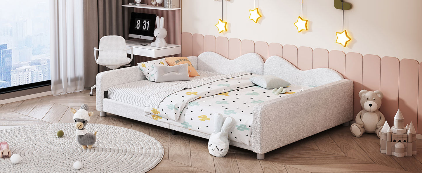 White upholstered twin bed with playful bedding and scattered plush toys