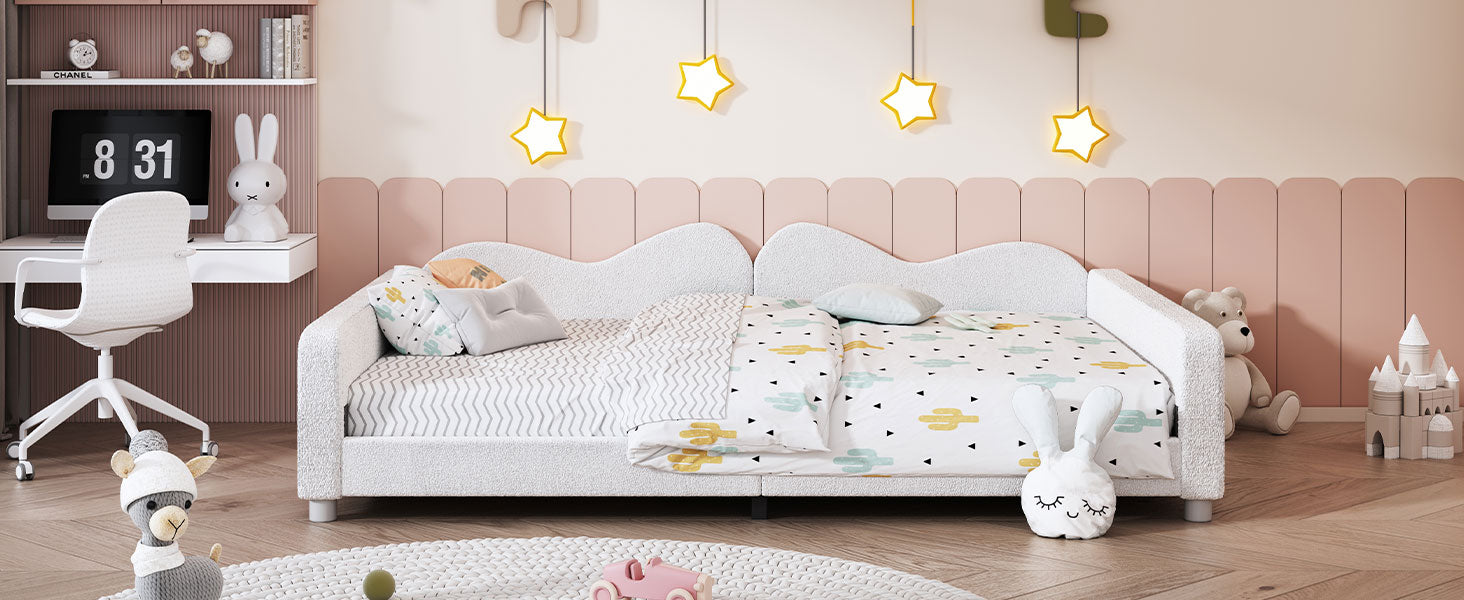 White upholstered twin bed with cactus print bedding and decorative pillows