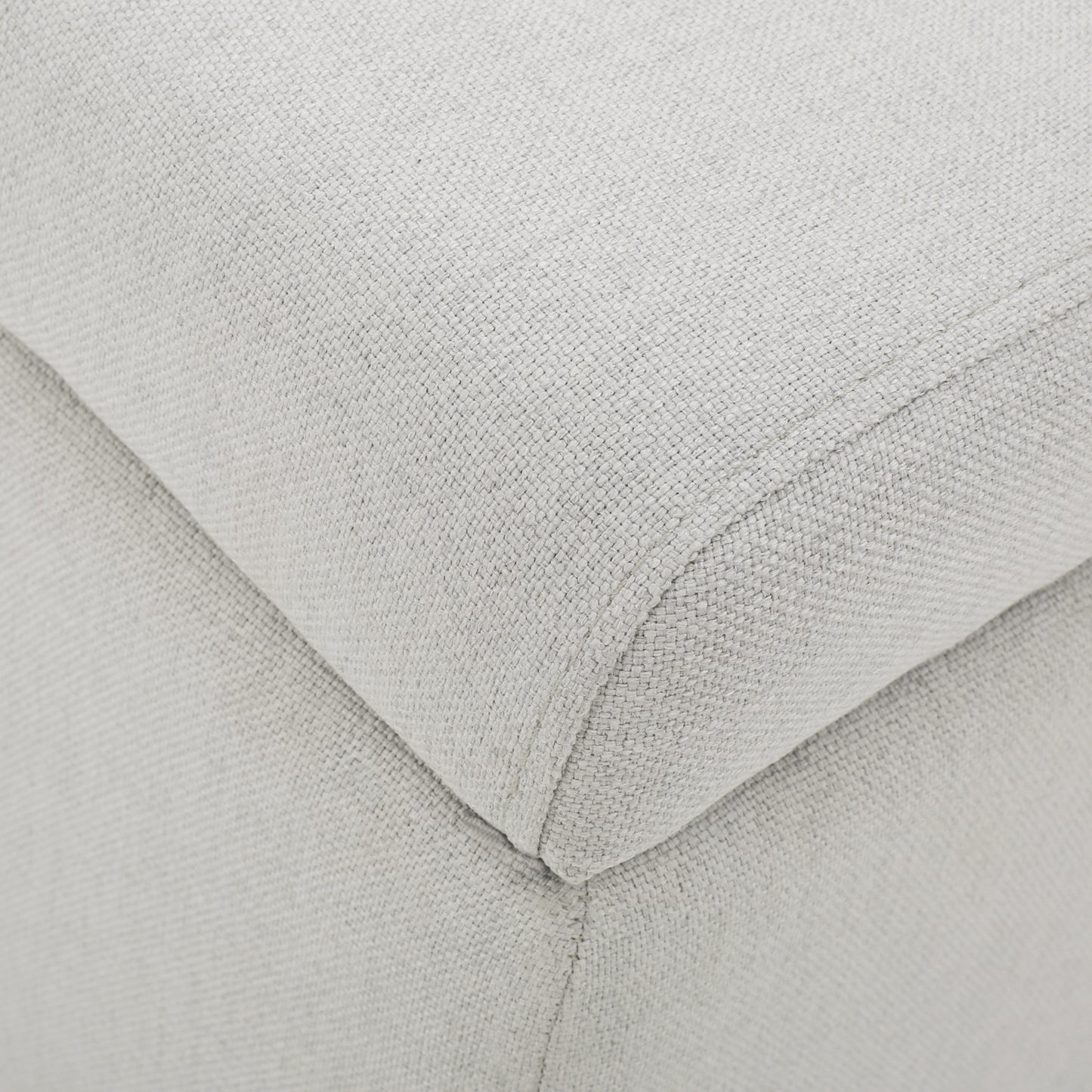 Closeup of textured light grey fabric upholstery on a modern sofa