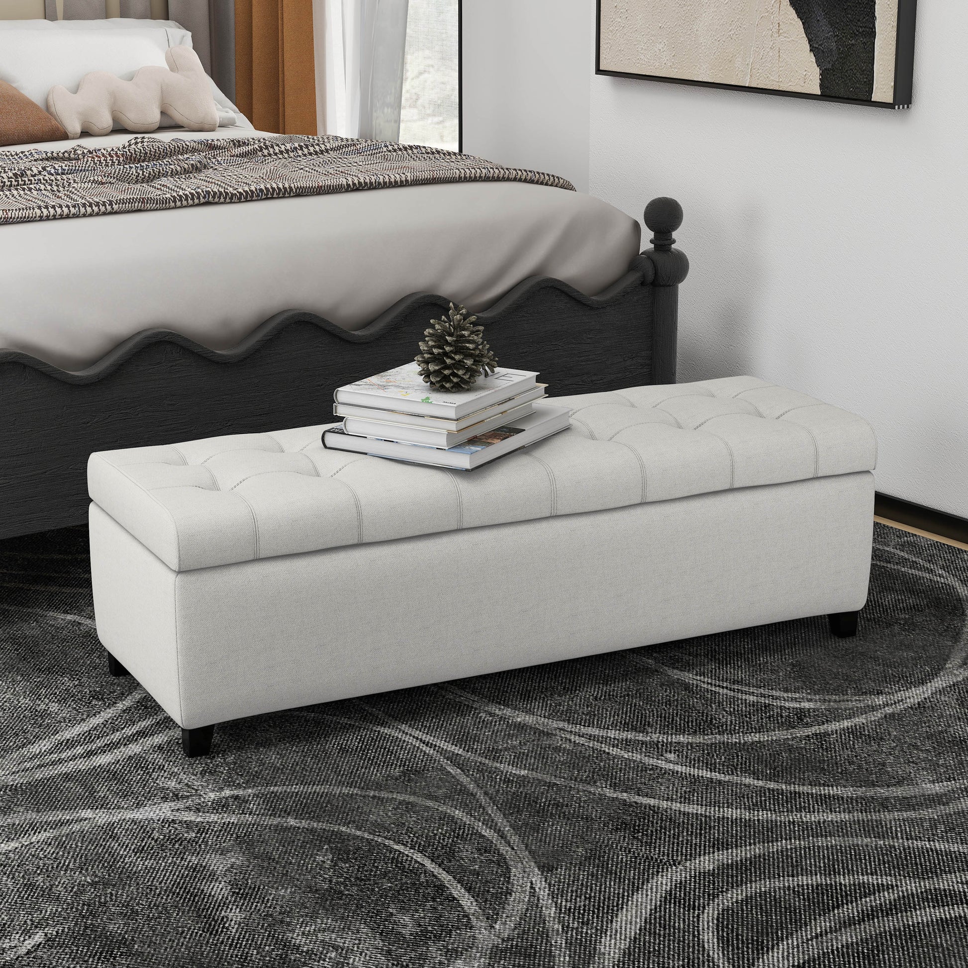 Cream upholstered storage bench with tufted lid and dark legs