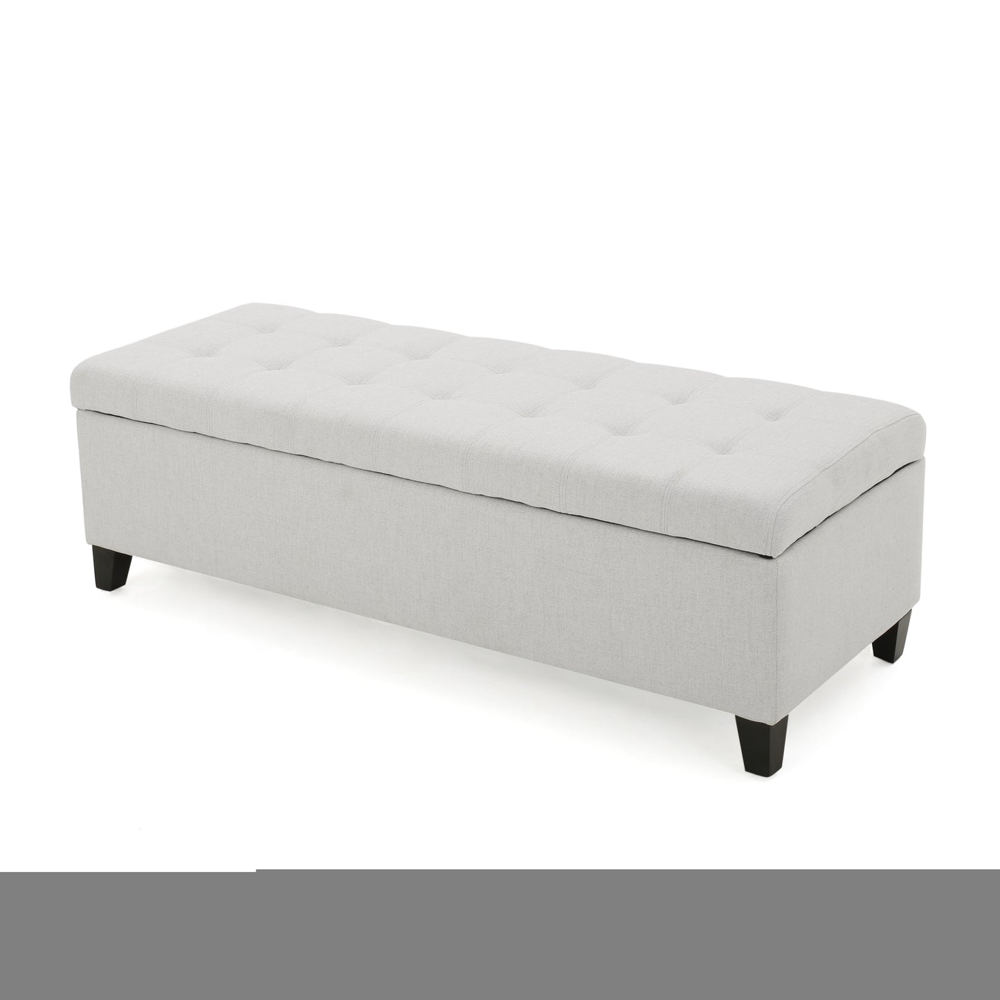 Tufted grey linen storage ottoman with dark wood legs