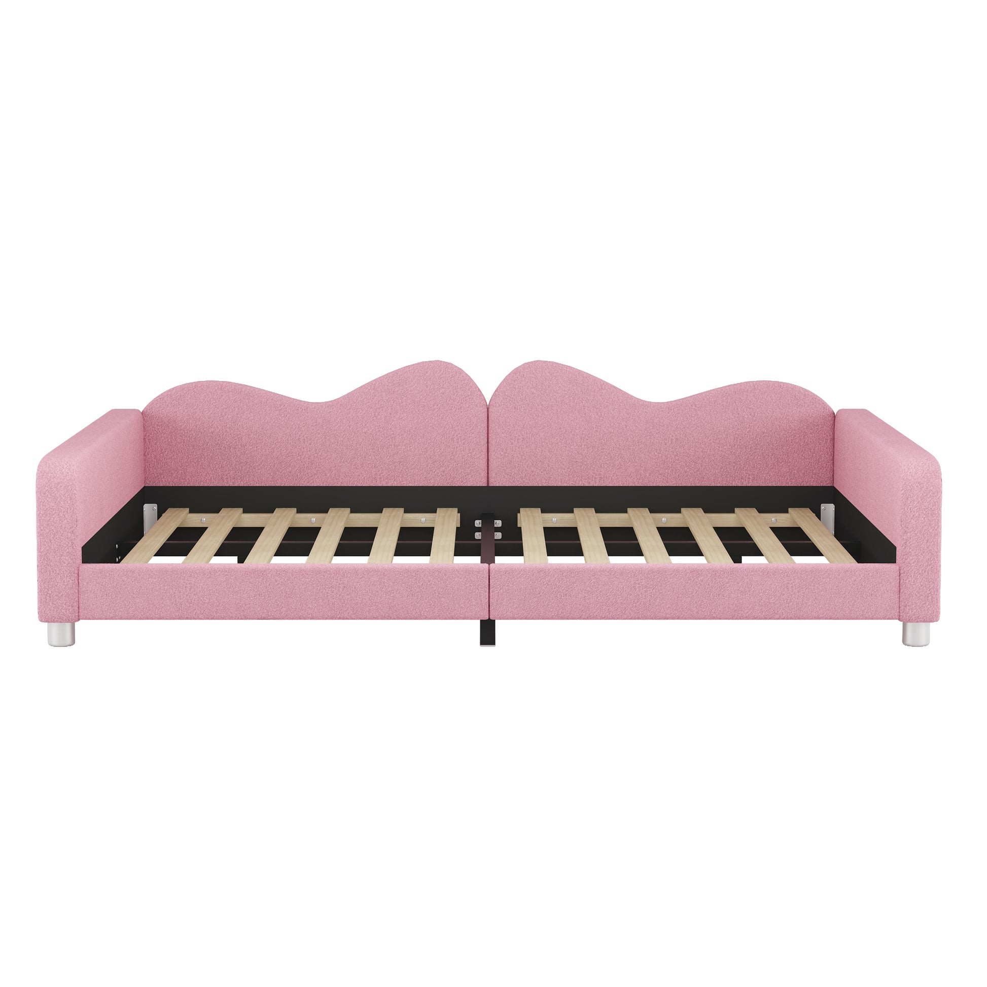 Pink upholstered daybed with a scalloped headboard perfect for kids rooms