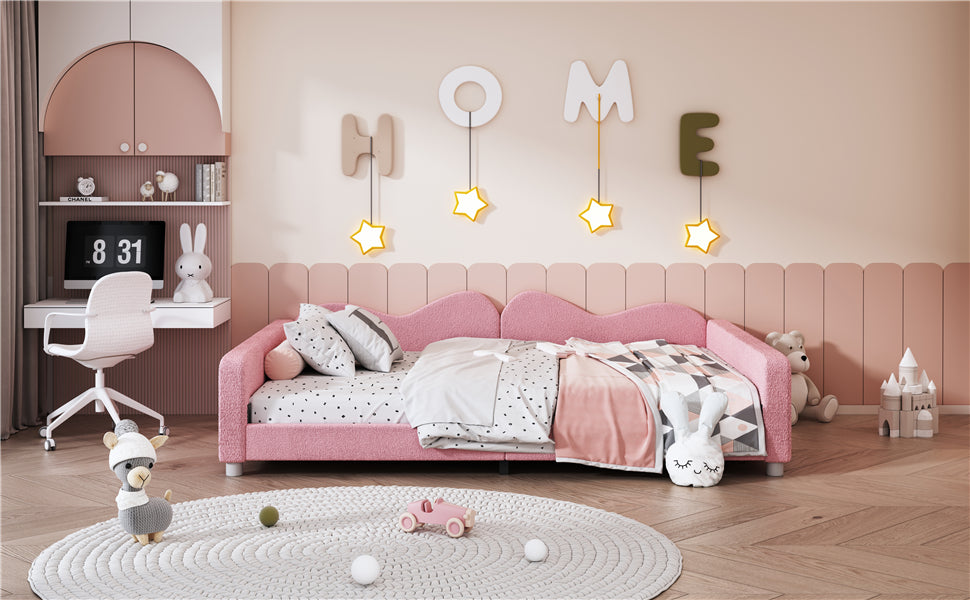 Pink upholstered twin bed with polka dot bedding and plush toys