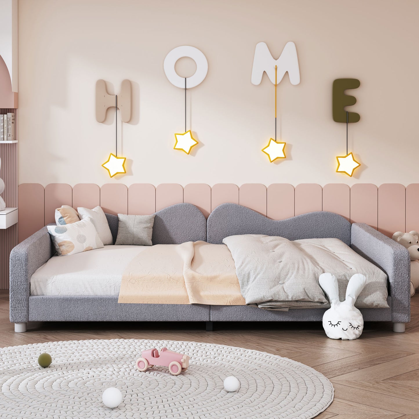 Cozy grey boucle toddler daybed with playful wave headboard and star lights