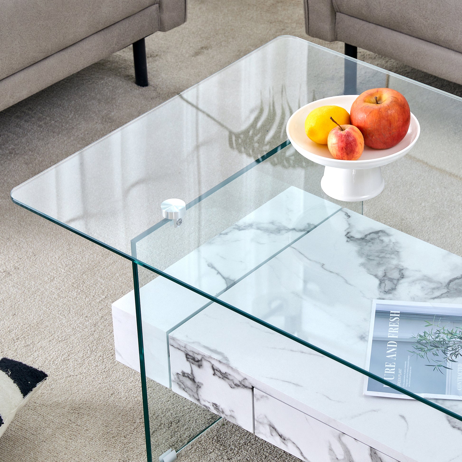 Modern clear glass coffee table with white marble effect drawers