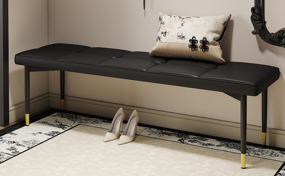 Black tufted upholstered bench with gold tipped legs