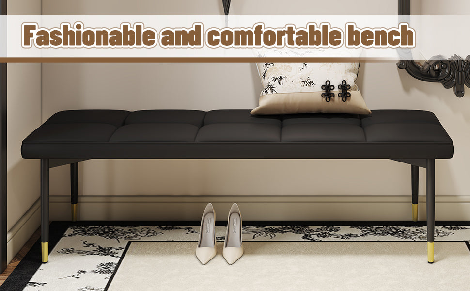 Black tufted bench with goldtipped legs
