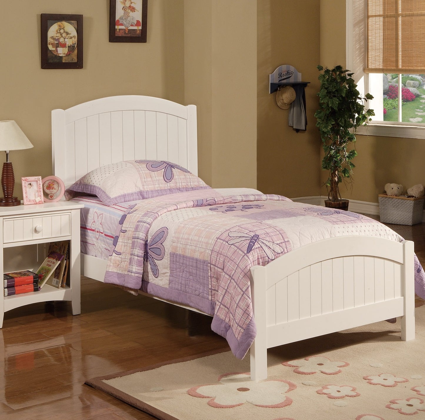 White wooden twin bed with purple butterfly quilt