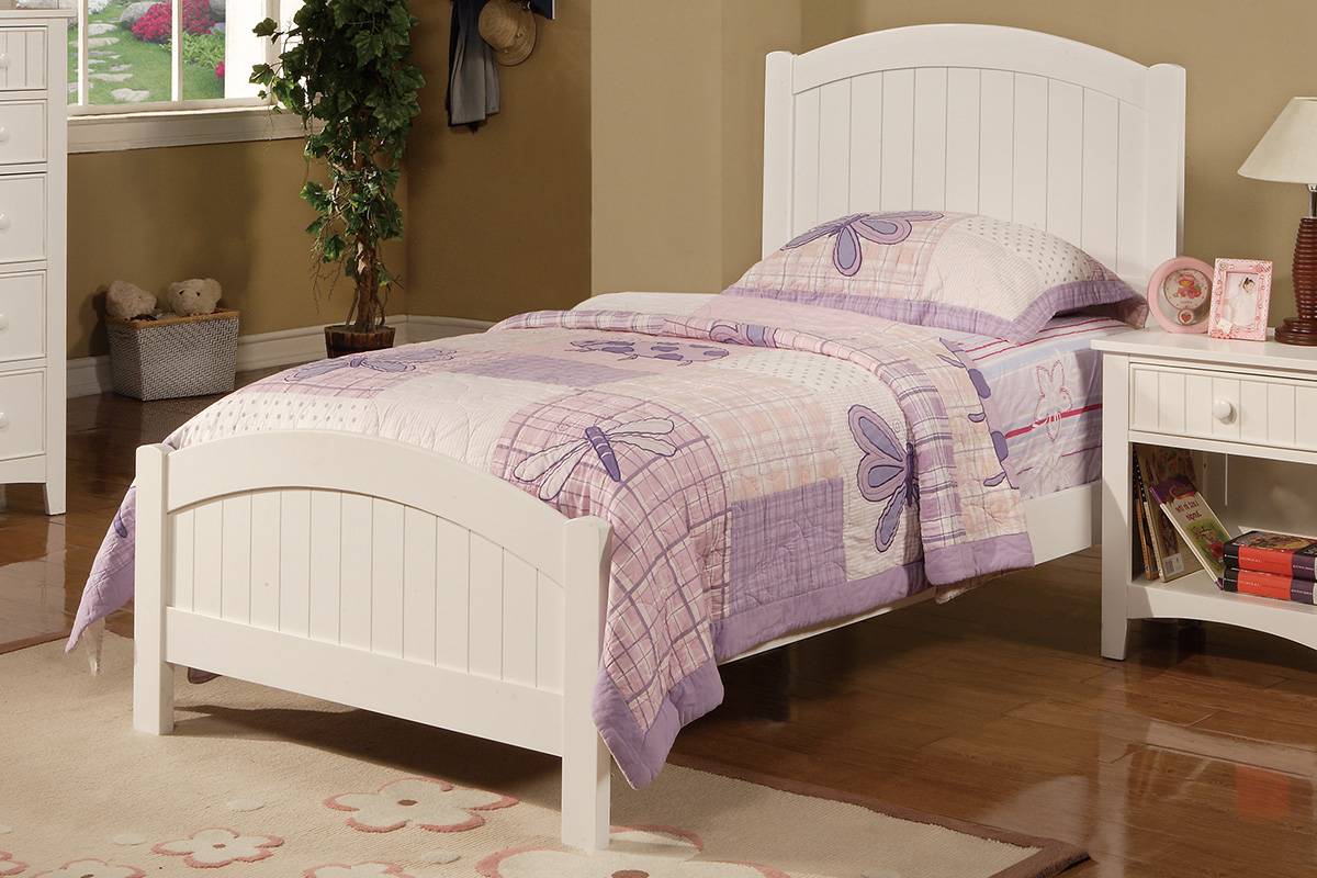 White wooden twin bed with purple dragonfly quilt and matching pillow