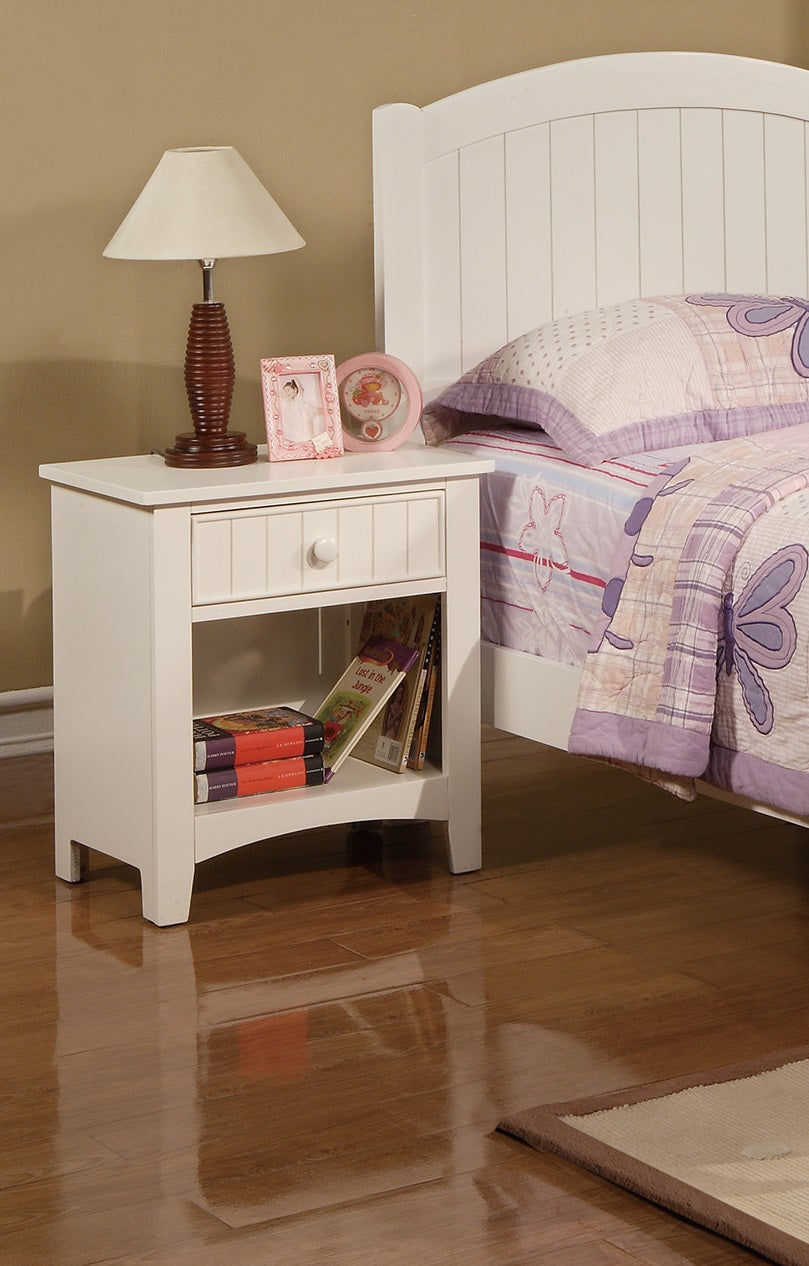 White wooden nightstand with drawer and open shelf displaying books
