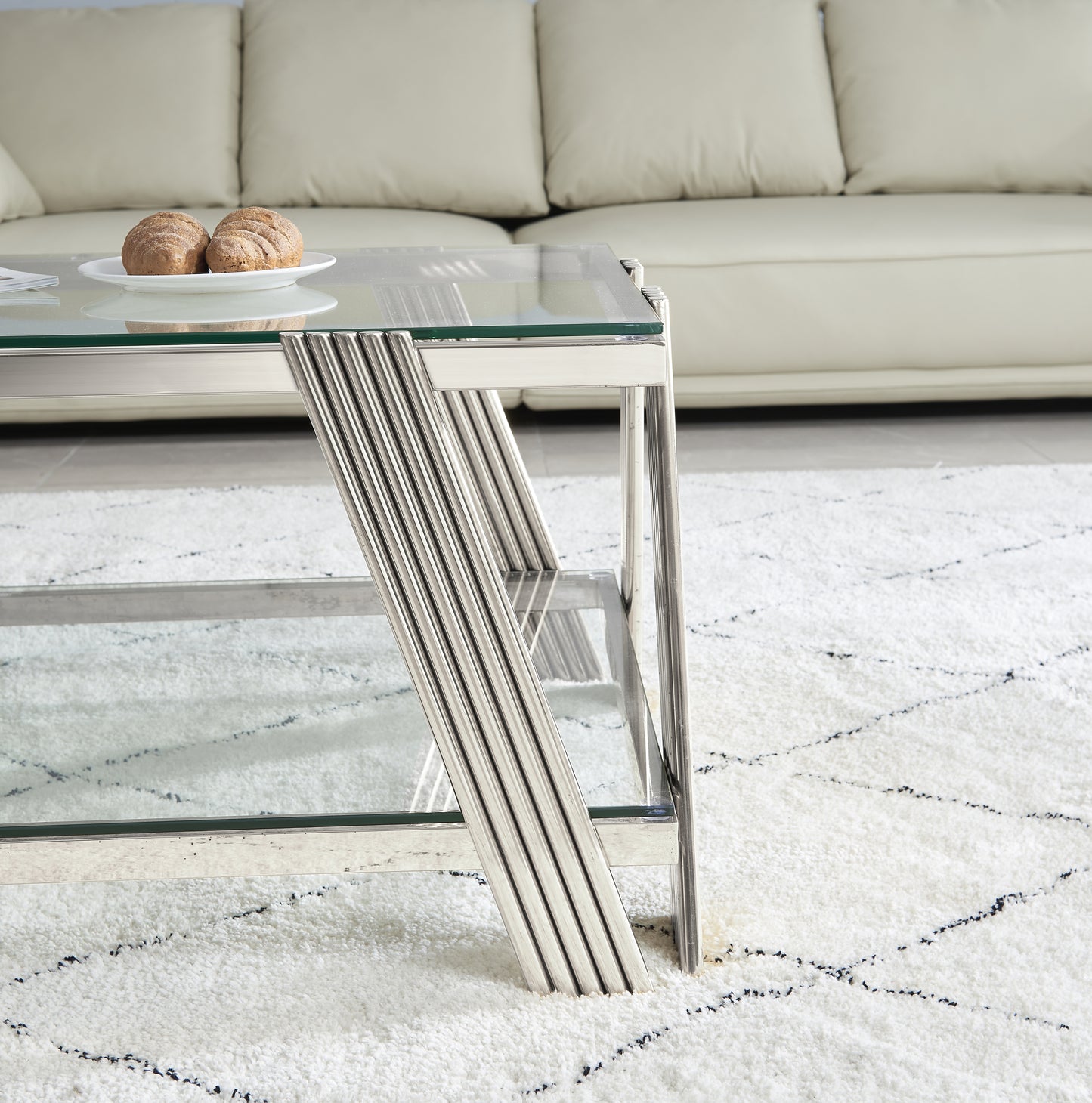 Modern glass and chrome coffee table with ribbed metal legs