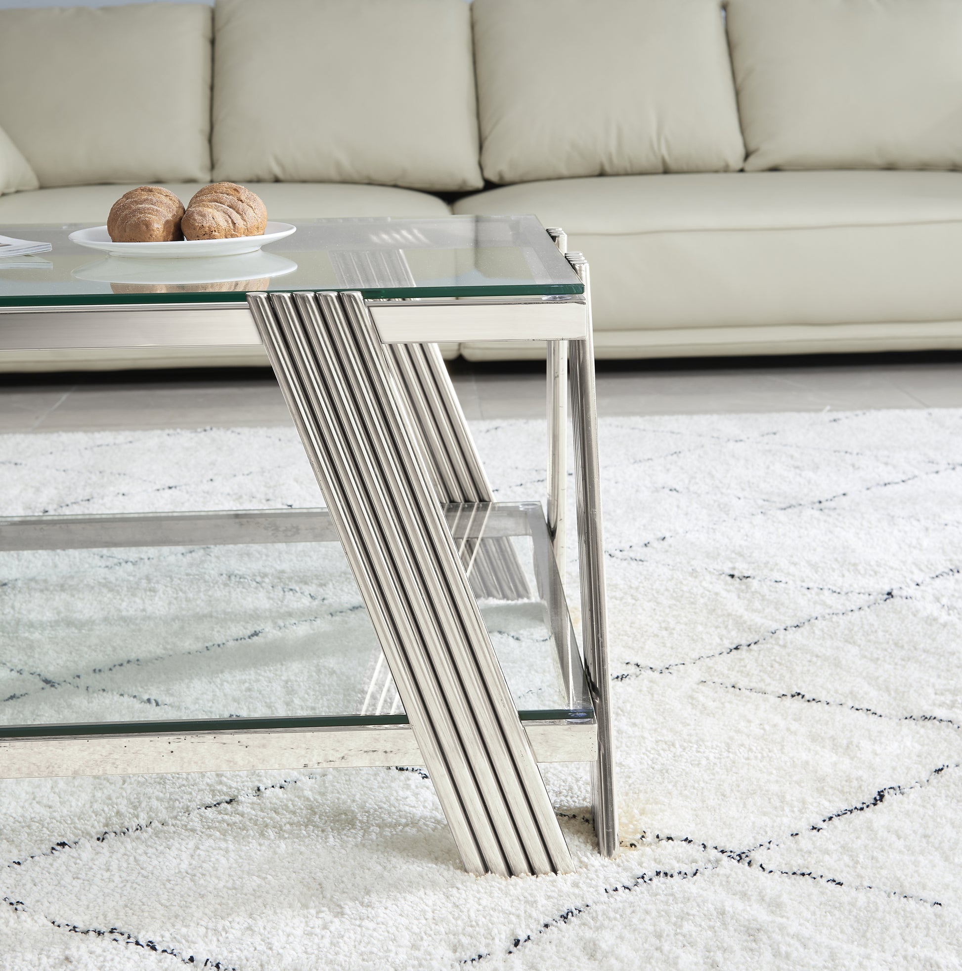 Modern glass and chrome coffee table with ribbed metal legs