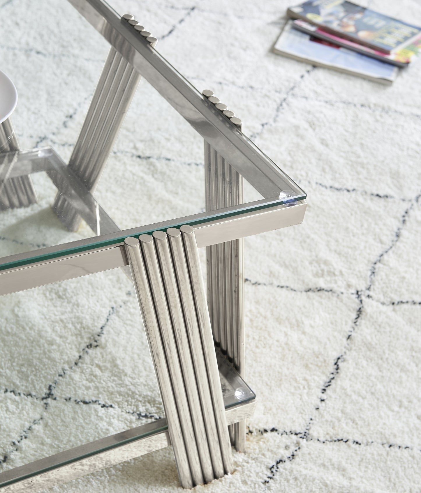 Glamorous silver coffee table with glass top and ribbed legs