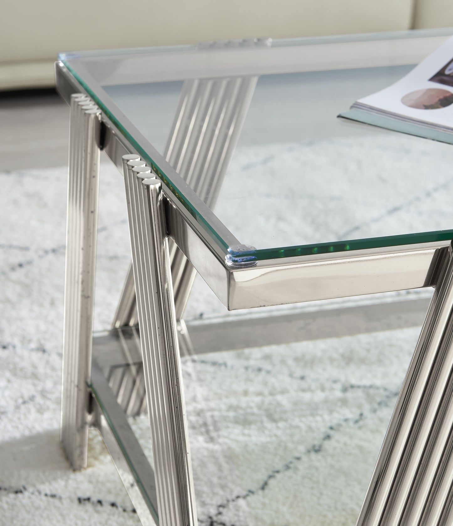 Polished chrome coffee table with fluted legs and a clear glass top