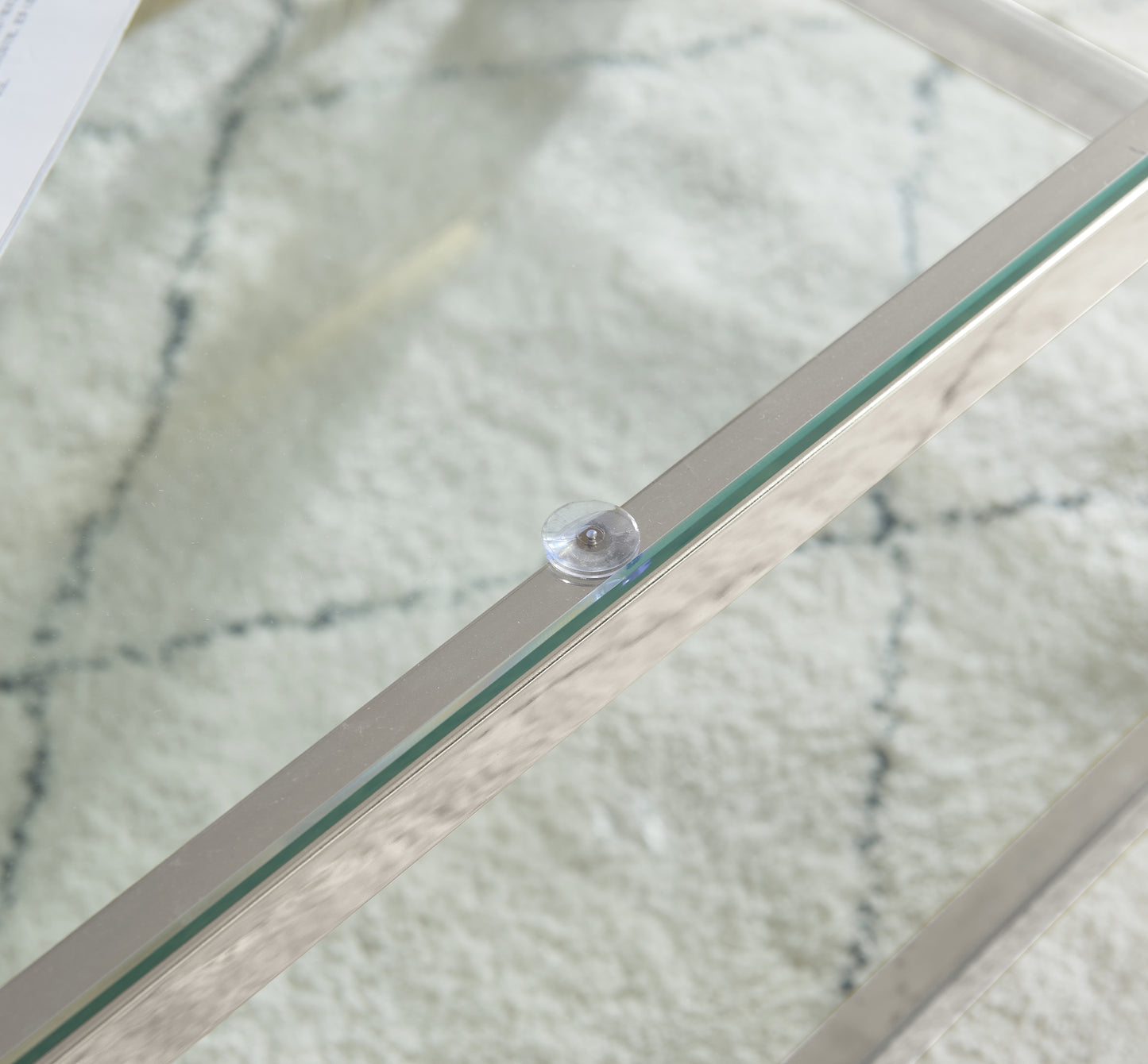 Polished silver frame with clear glass tabletop detail