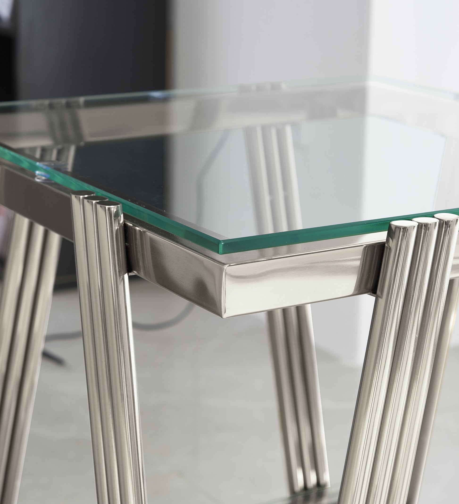 Glass top side table with brushed nickel fluted legs