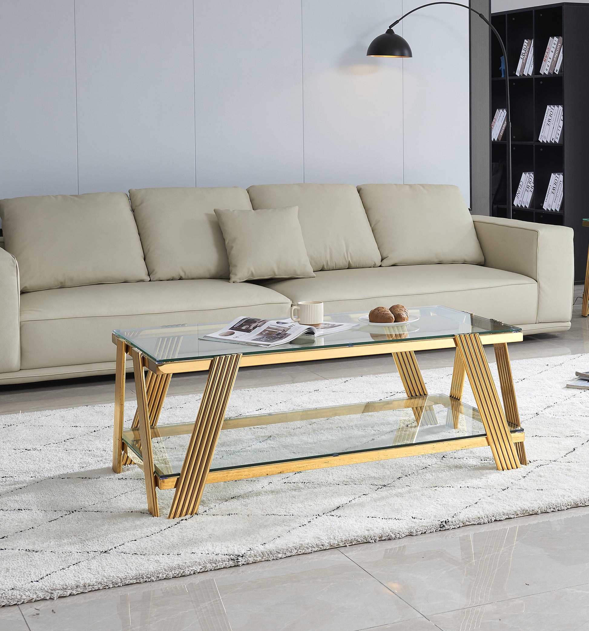 Modern glass coffee table with gold geometric legs