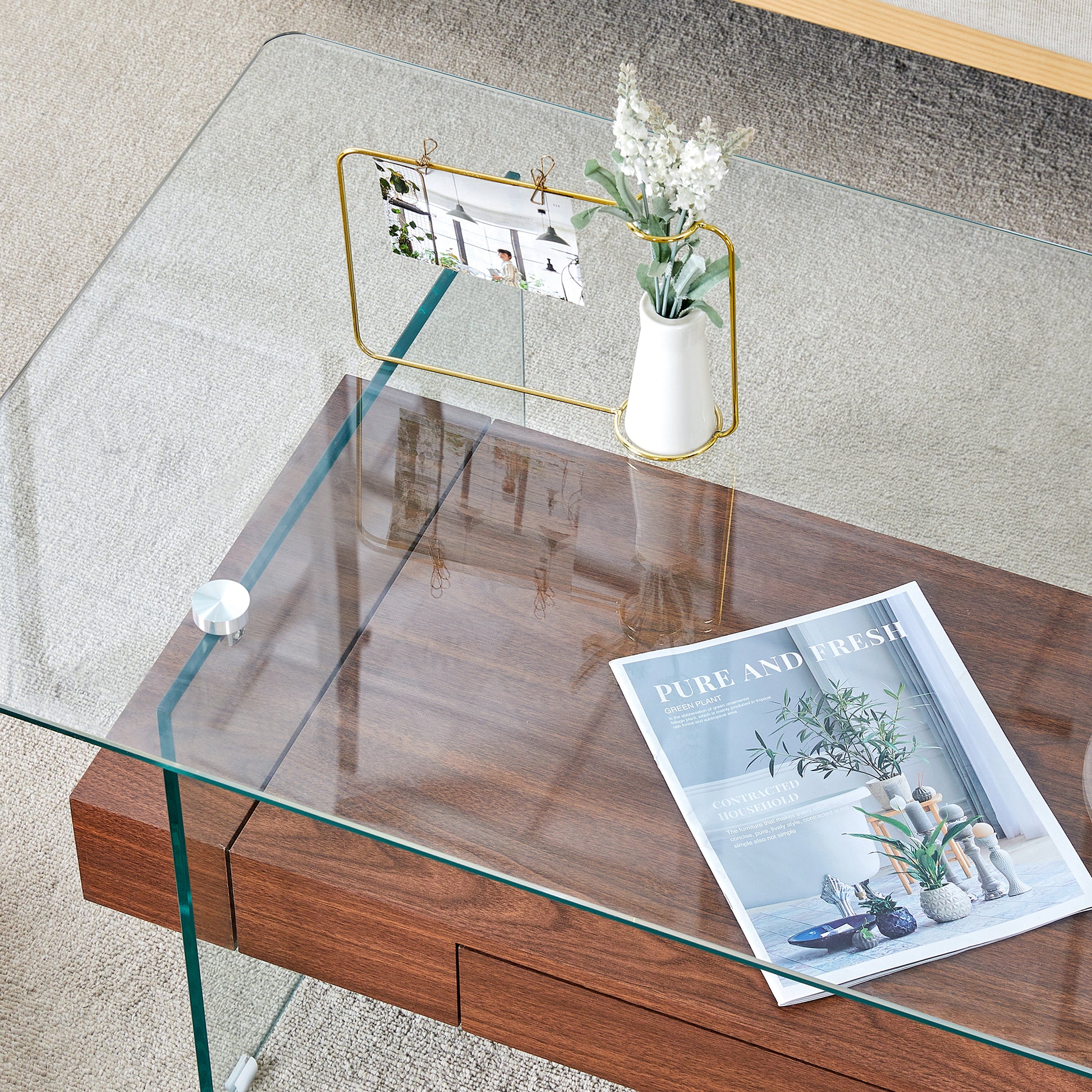 Glass top coffee table with dark wood drawers