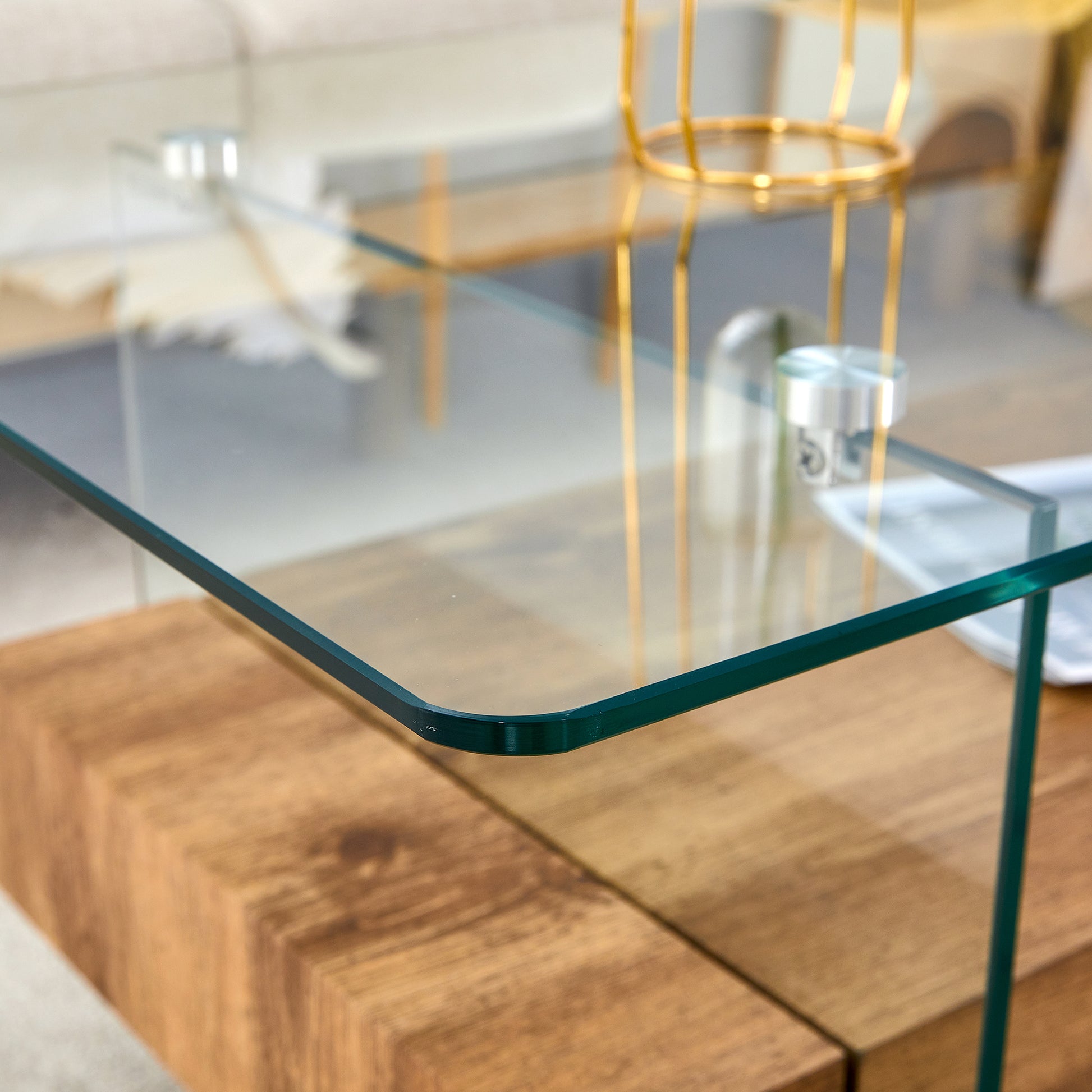 Modern clear glass coffee table with a natural wood base