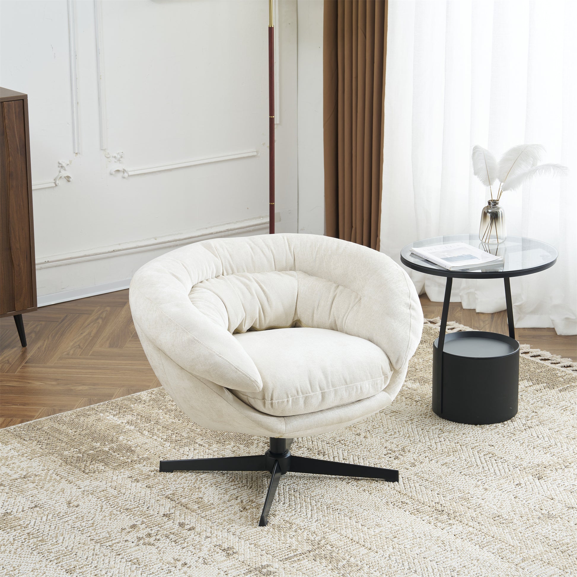 Plush ivory swivel chair with deep seat cushions and a curved back perfect for reading nooks