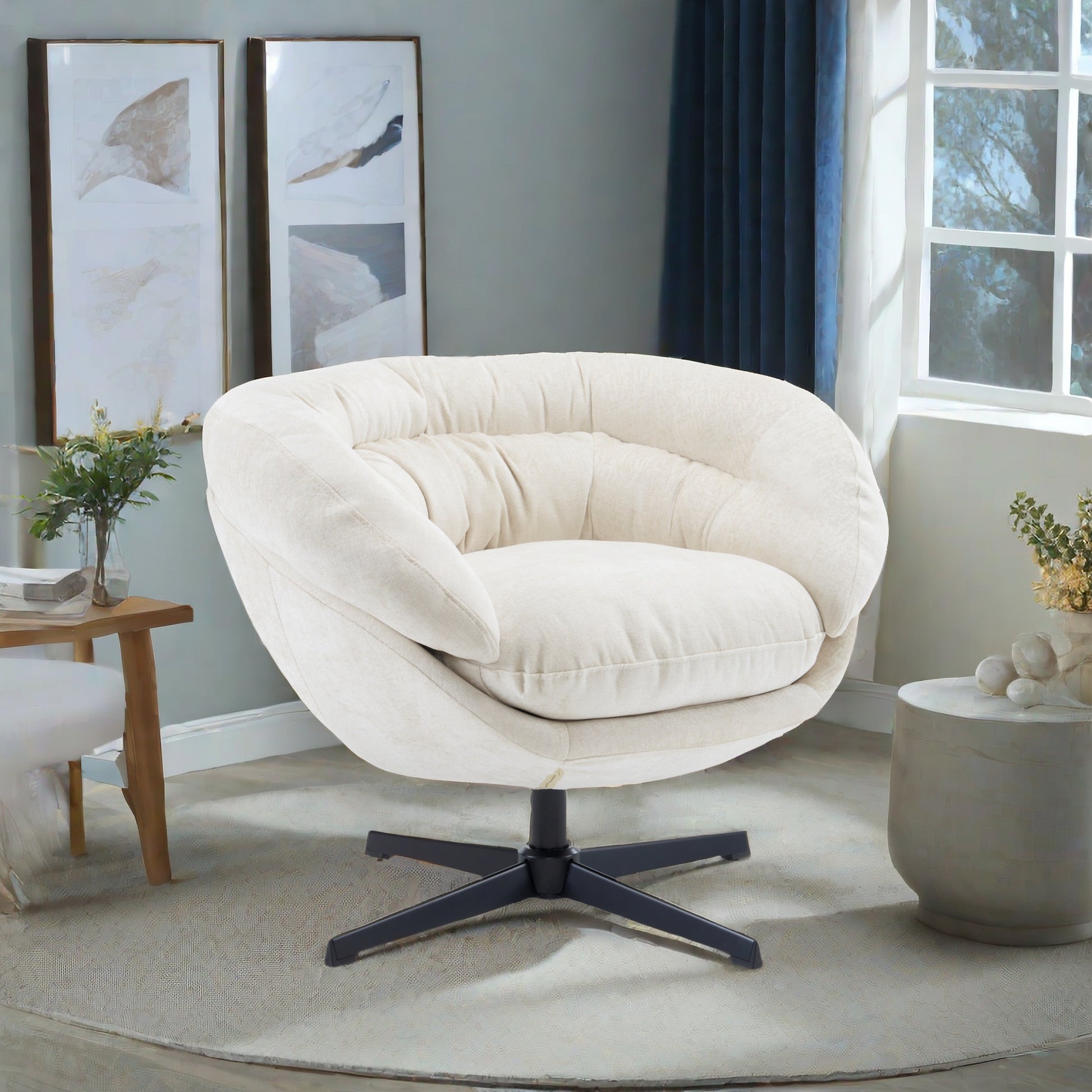 Cream swivel accent chair with plush upholstery and modern black base