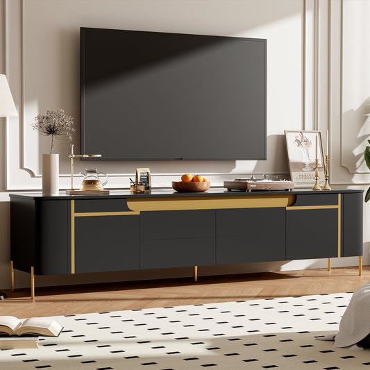 Black media console with gold accents and tapered legs