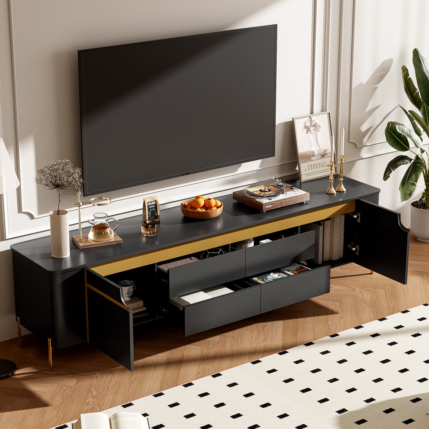 Black media console with gold accents and open drawers