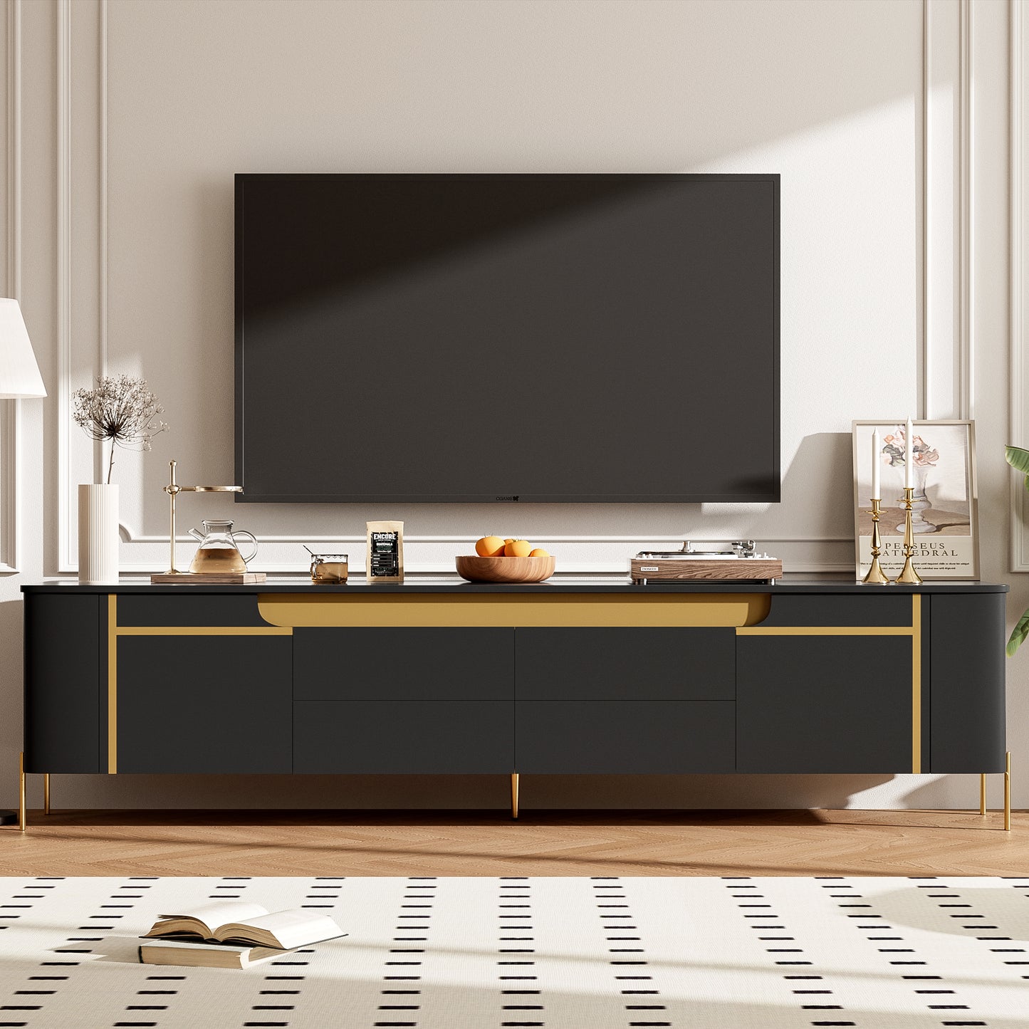 Black media console with gold accents and brass legs