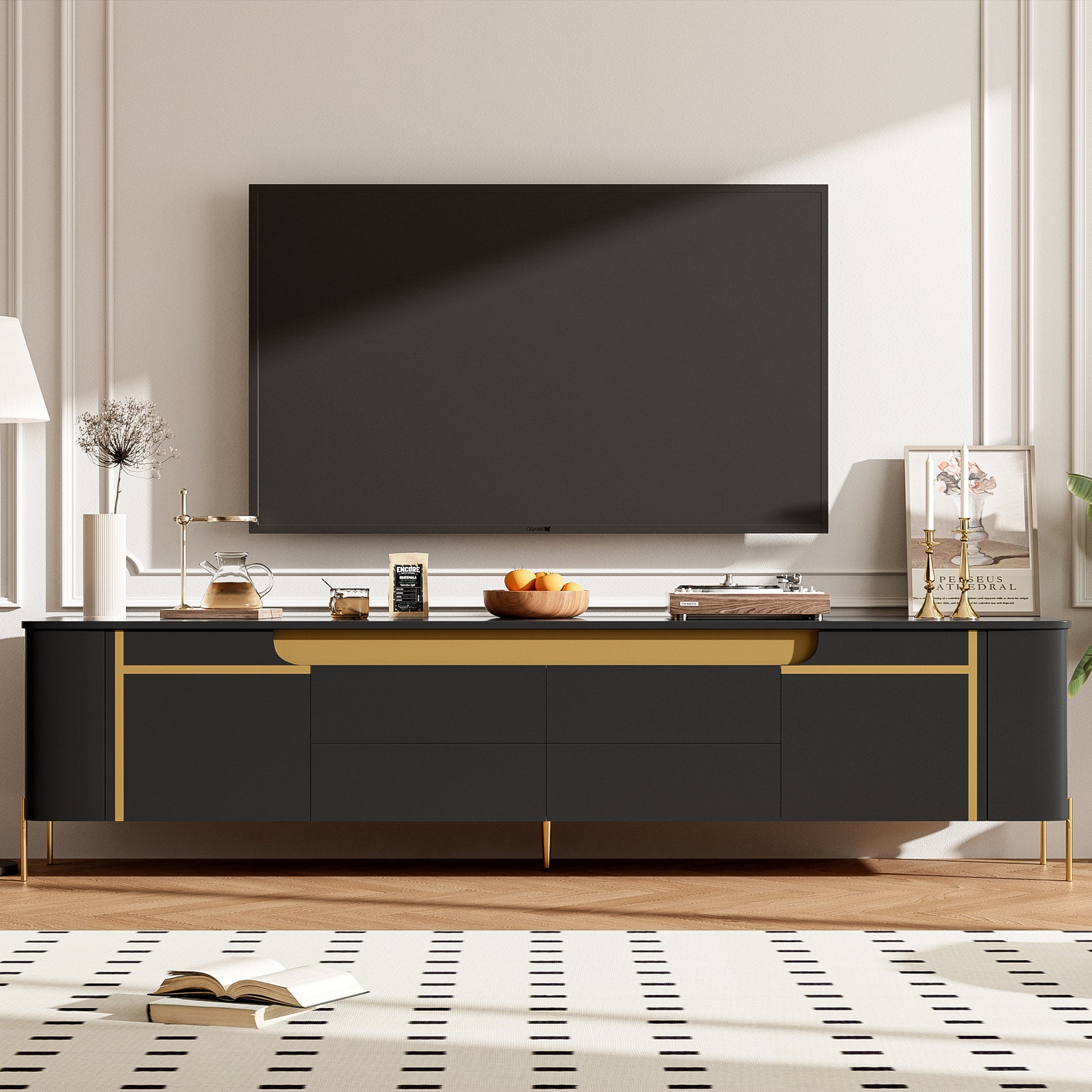 Black media console with gold accents and brass legs