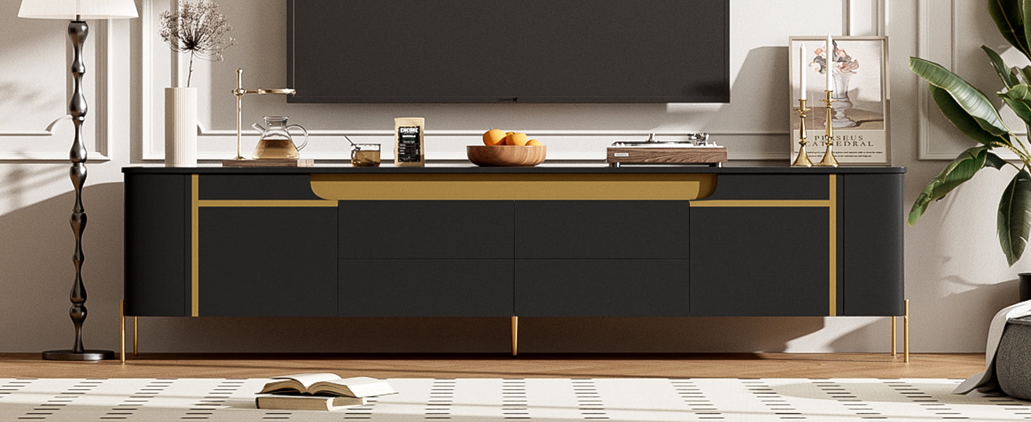 Modern black media console with gold accents and slender legs