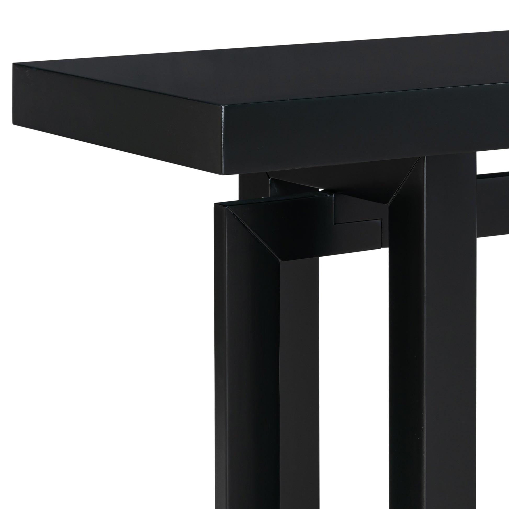 Closeup of a matte black metal console table leg with geometric detail