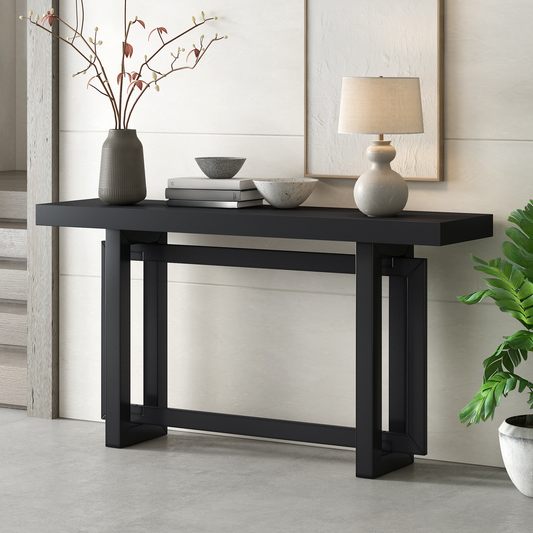 Modern black metal console table with geometric legs and decorative vase