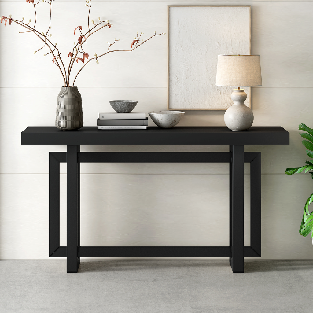 Black geometric console table with decorative objects