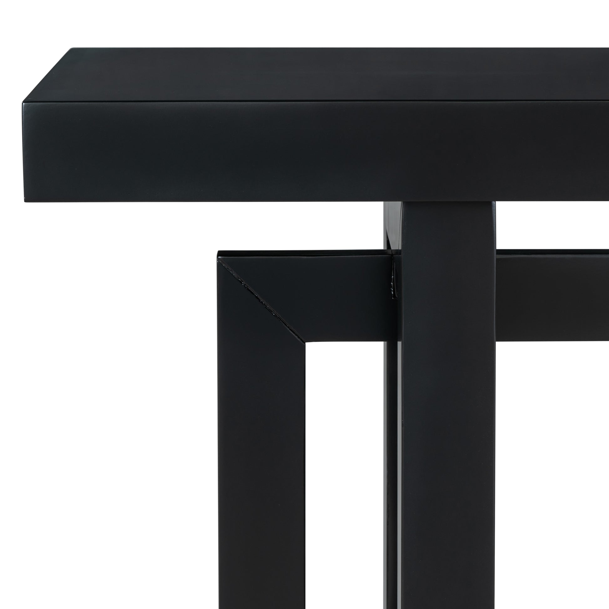 Closeup of a modern black metal coffee table with clean lines and a matte finish