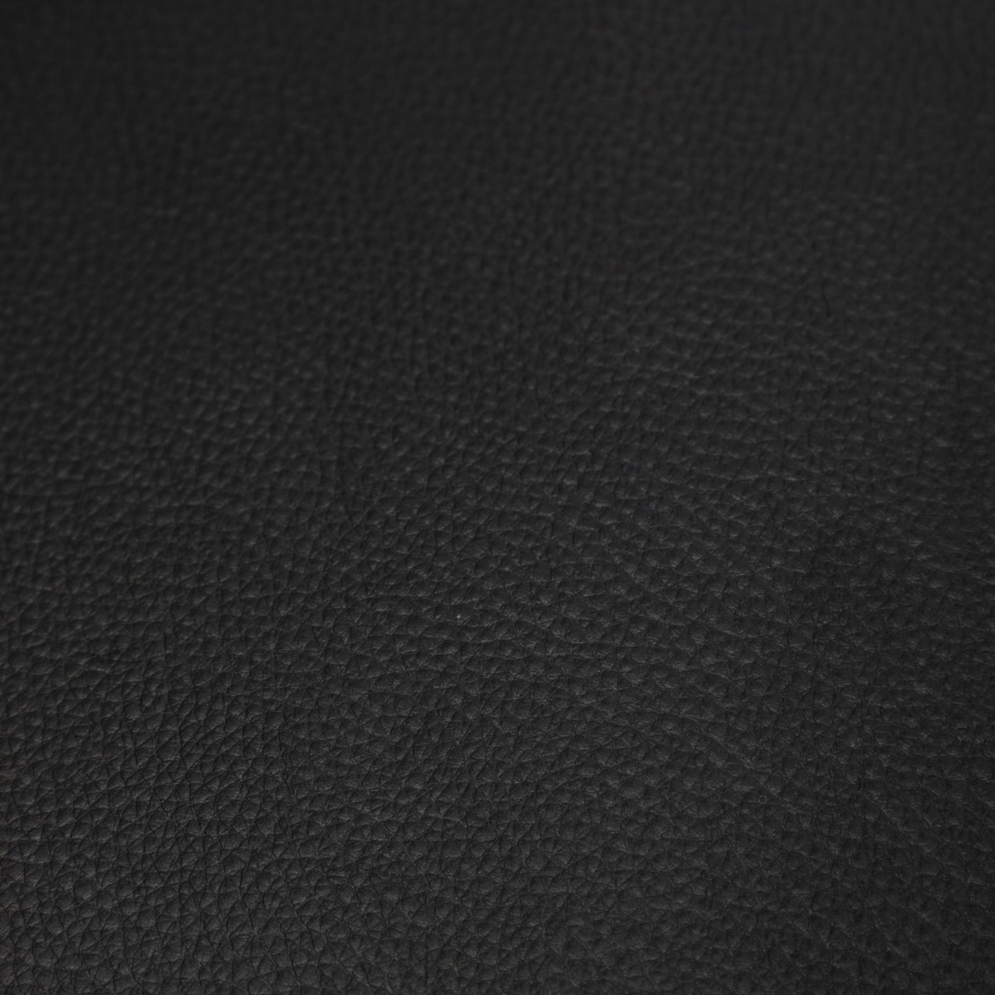 Closeup texture of black genuine leather material