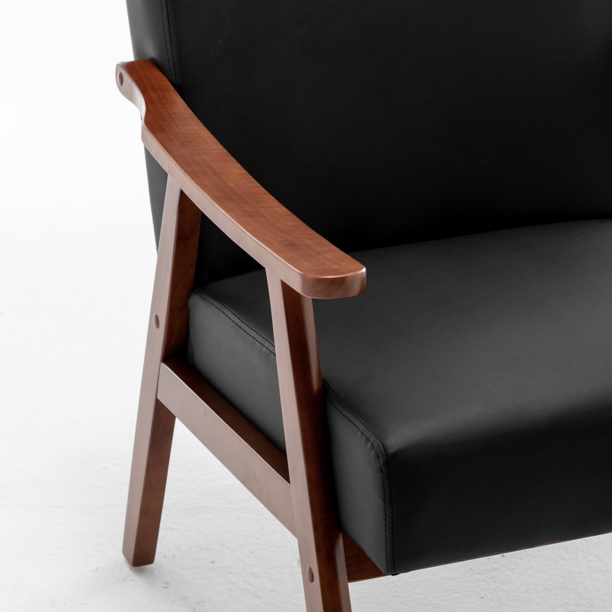 Black leather armchair with rich walnut wood accents