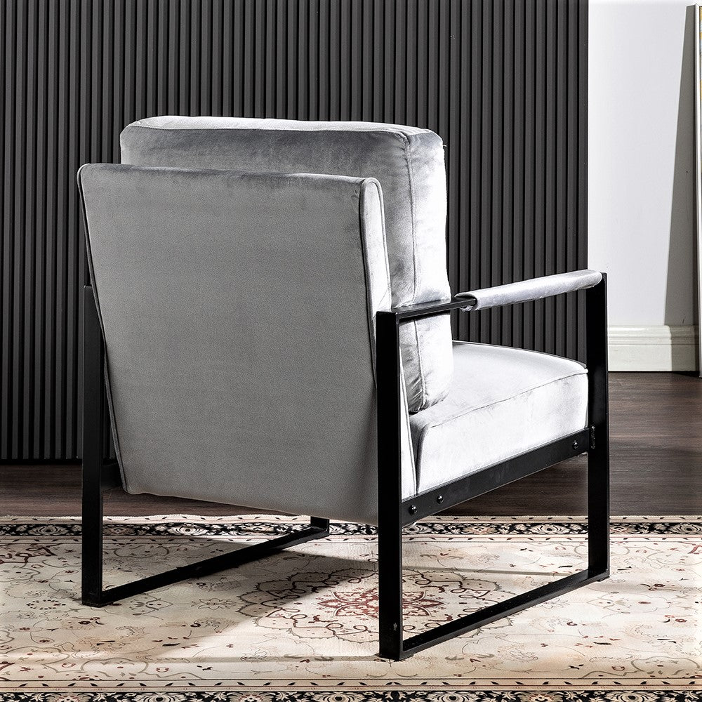 Plush gray velvet armchair with sleek black metal frame