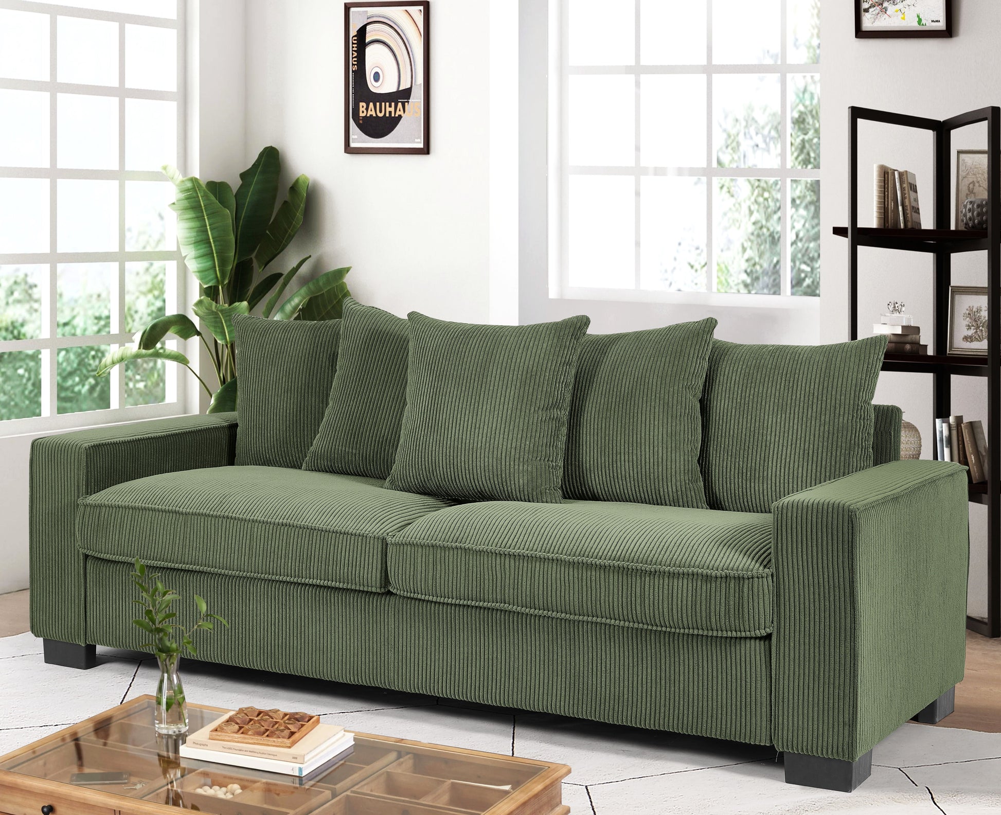 Green corduroy threeseater sofa with plush cushions