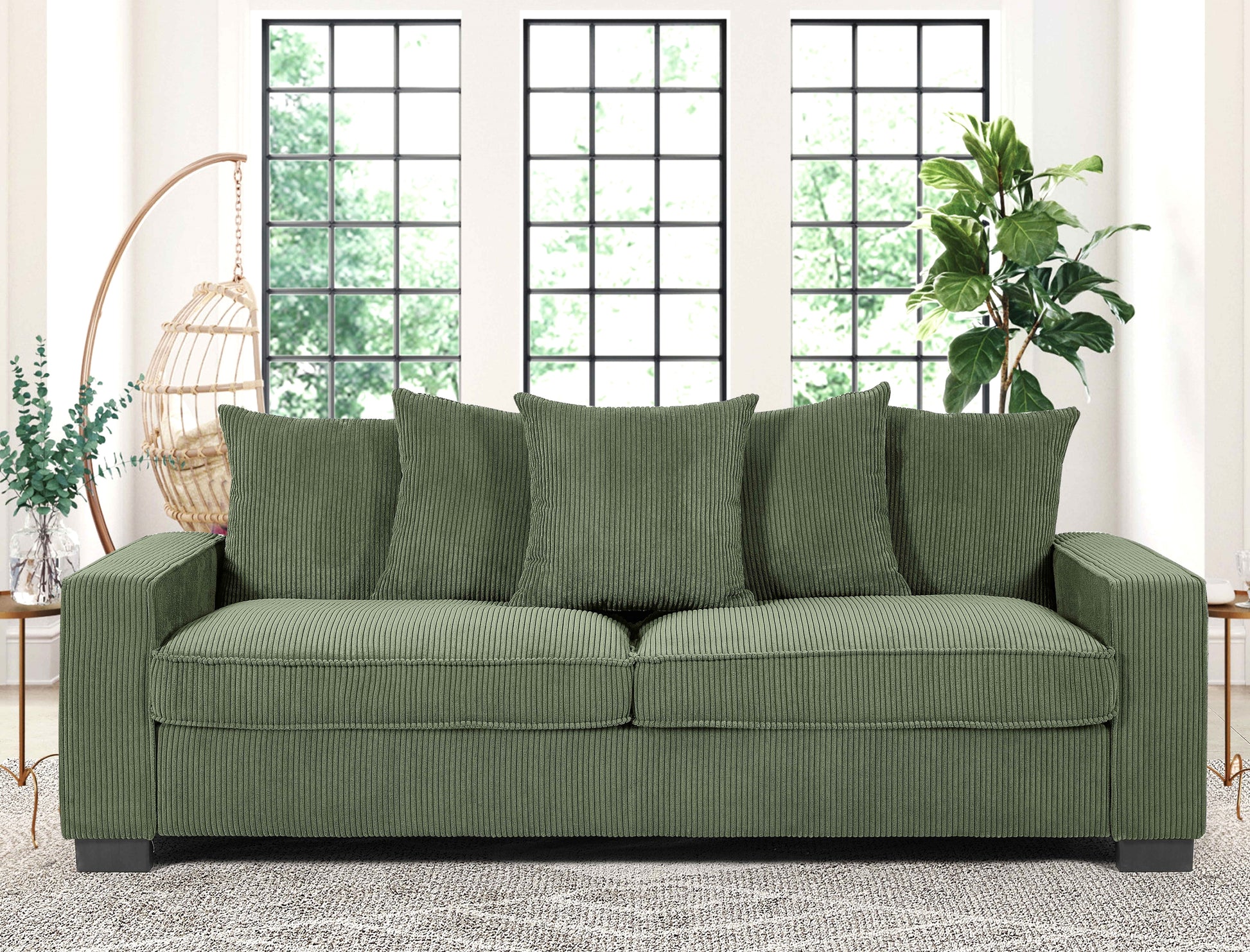 Green corduroy sofa with plush cushions and elegant piping