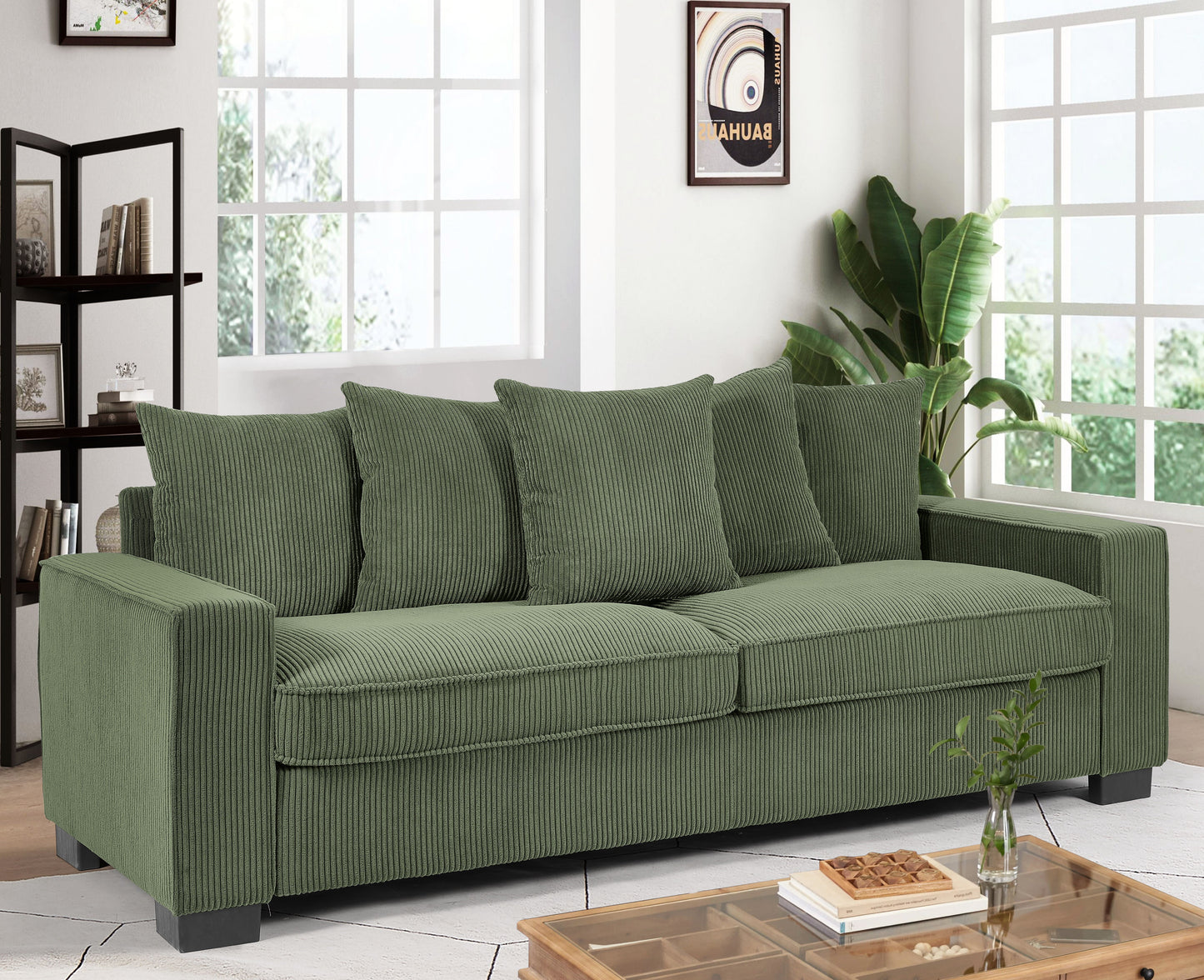 Green corduroy sofa with plush cushions and dark wood legs