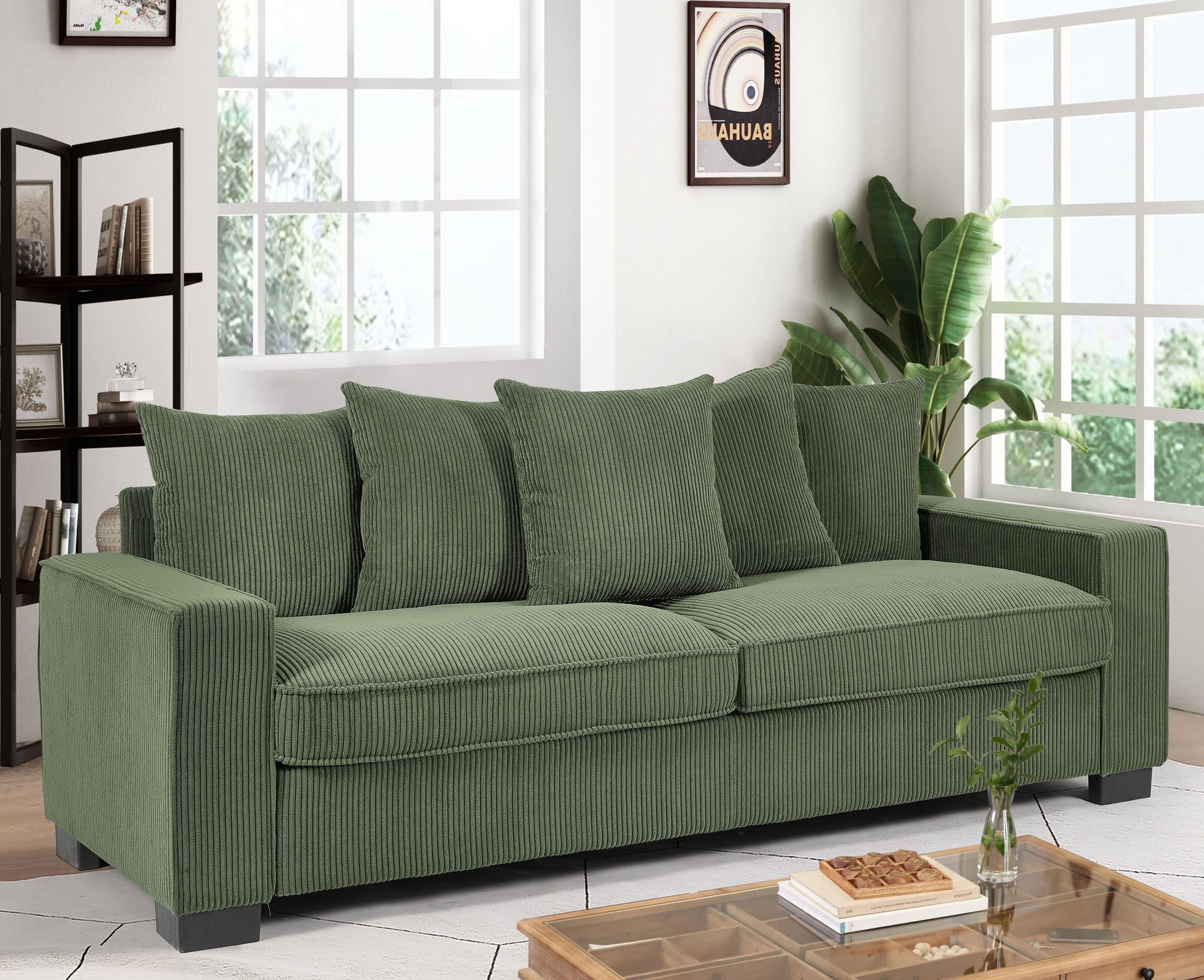Green corduroy sofa with plush cushions and dark wood legs
