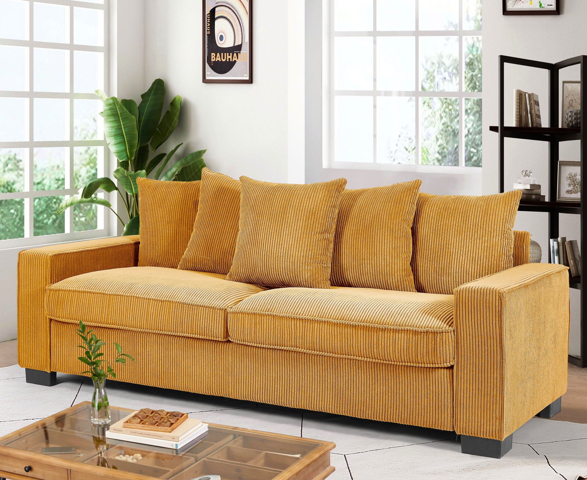 Mustard yellow corduroy sofa with plush cushions and wooden frame