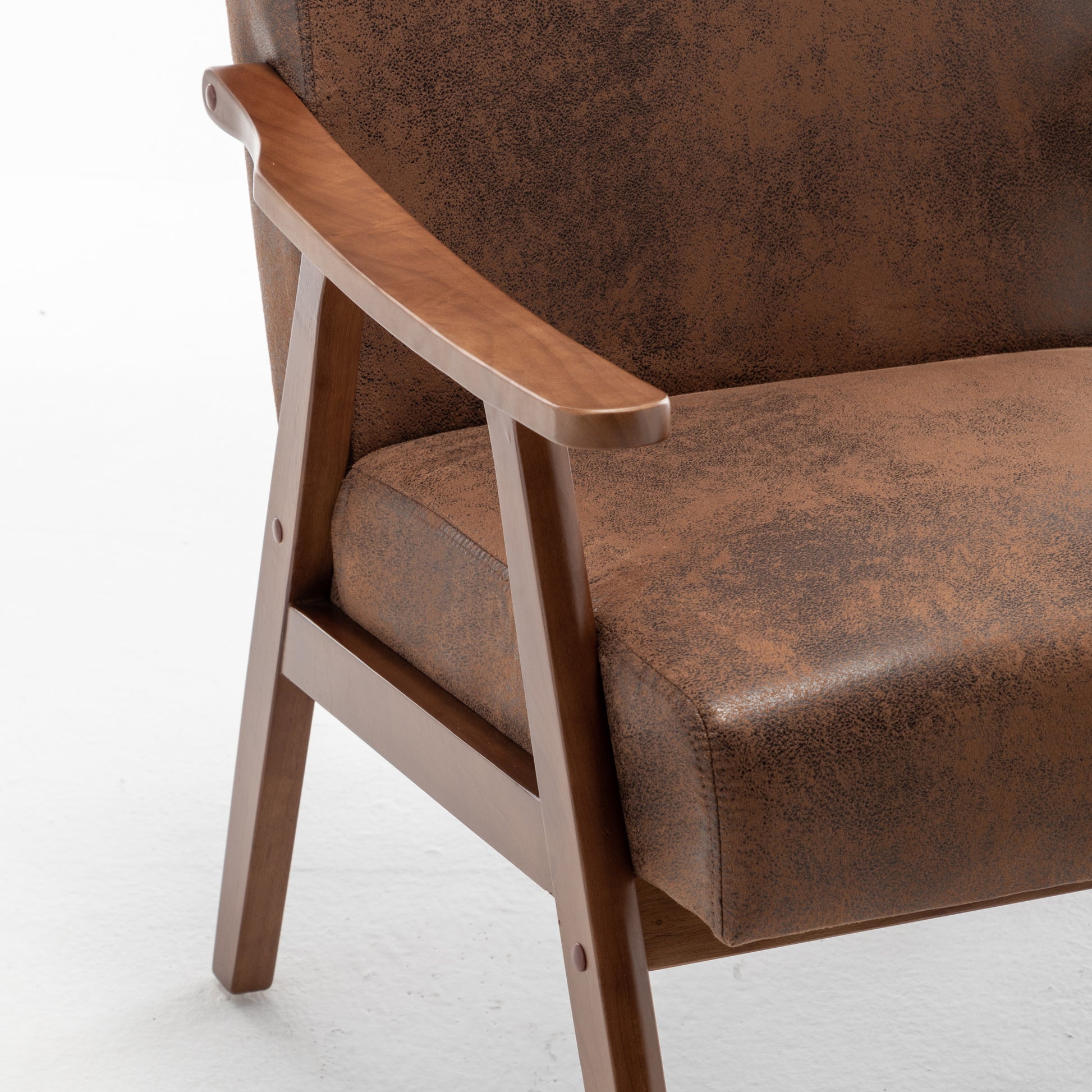 Brown suede armchair with light wood armrests and frame