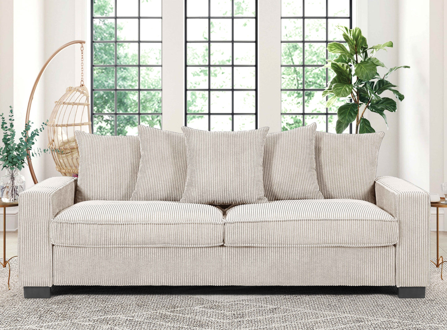 Cream corduroy sofa with four plush throw pillows perfect for a living room