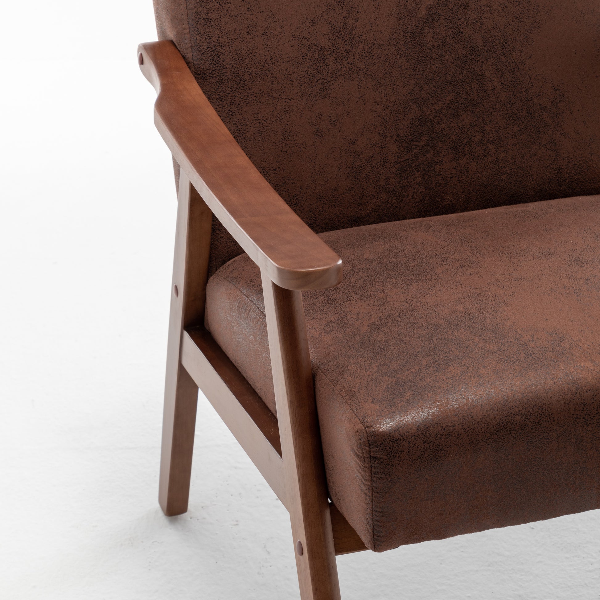 Brown suede armchair with wooden armrests and frame