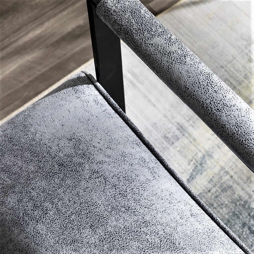 Textured gray fabric armchair seat with black metal armrest detail