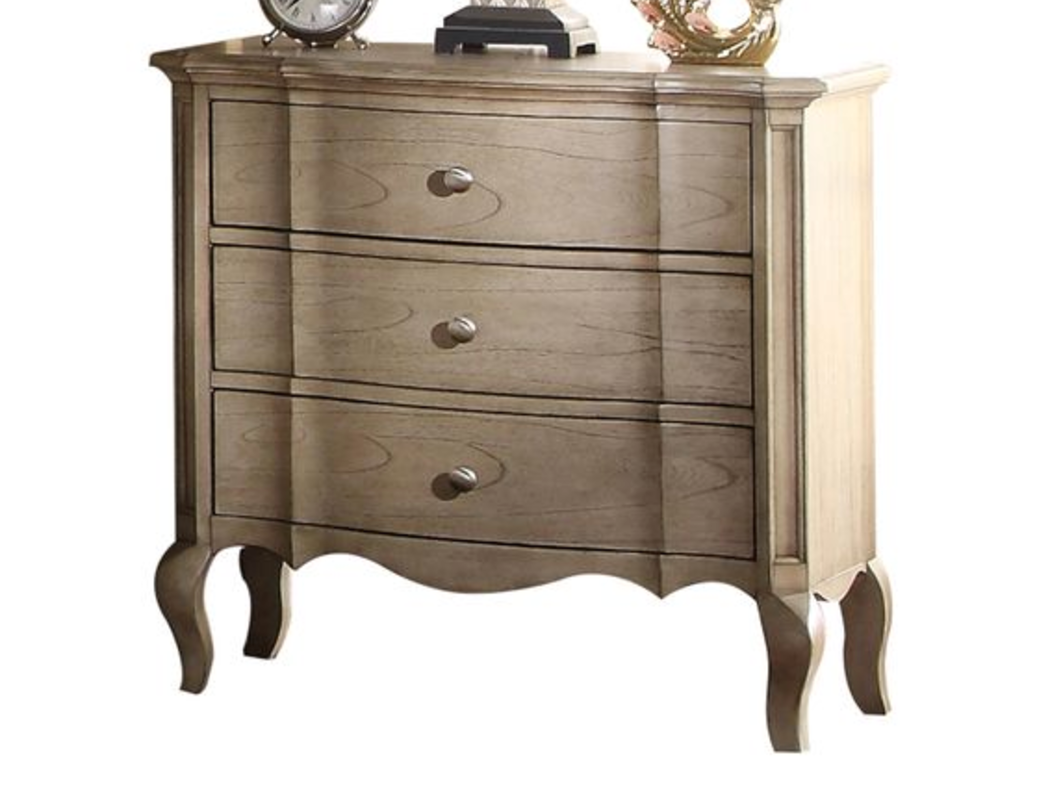 Antique white wood dresser with three curved drawers and ornate legs