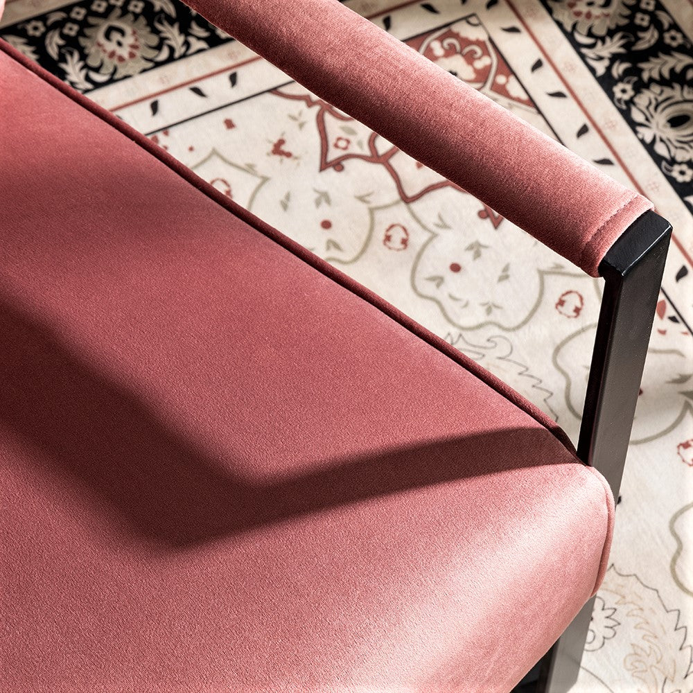 Closeup of plush rose velvet accent chair seat and armrest