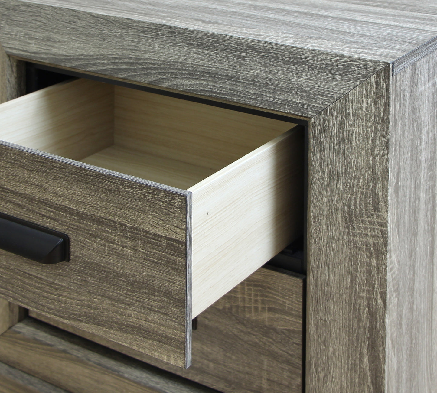 Rustic oak dresser with partially open drawer and black handle